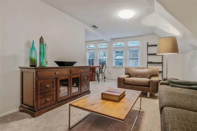 a view of a dining room with furniture and chandelier