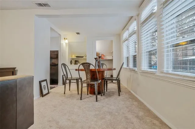 a kitchen with white cabinets and appliances