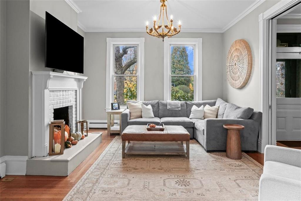 719 College Street Pittsburgh, PA 15232 - Photo 5 of 50 a living room with furniture a fireplace and a flat screen tv