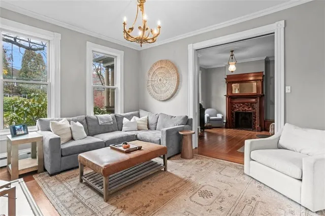 a living room with furniture a fireplace and a flat screen tv