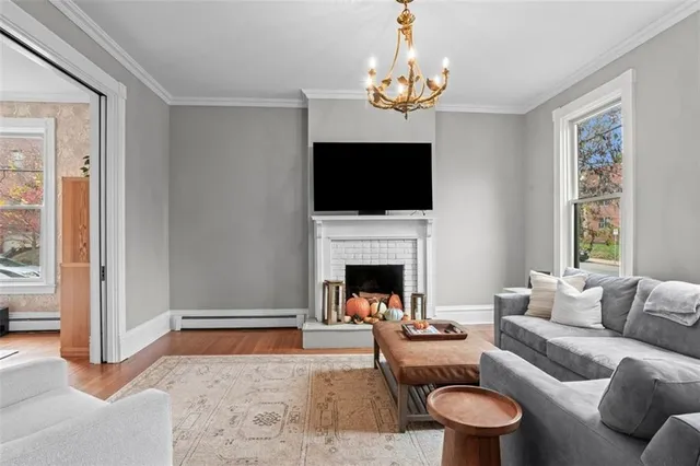 a living room with furniture a rug and a chandelier