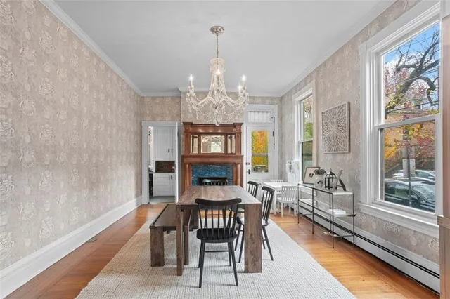 a view of a a dining room with furniture window and wooden floor