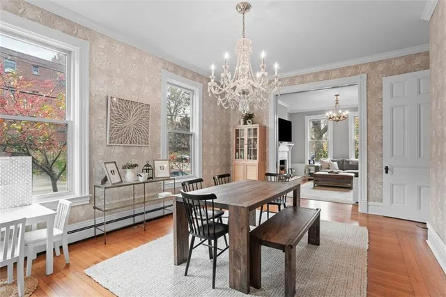 a dining room with furniture a fireplace and wooden floor