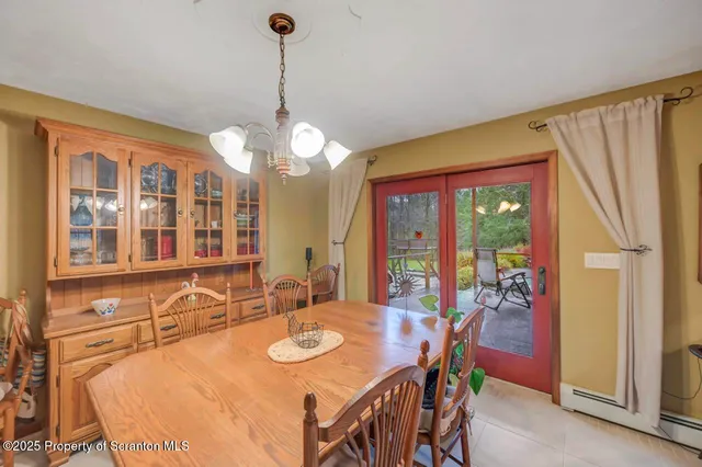 a bedroom with a bed and a large window with chair