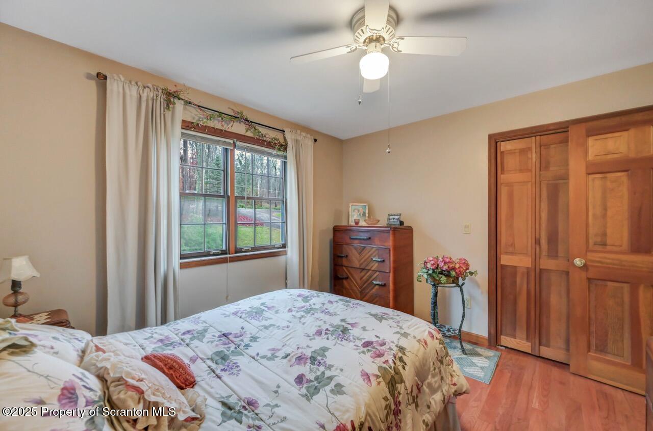 99 Main Street Gouldsboro, PA 18424 - Photo 38 of 79 a bedroom with a bed and a chandelier