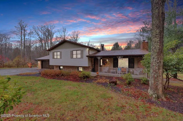 a front view of a house with a garden and yard