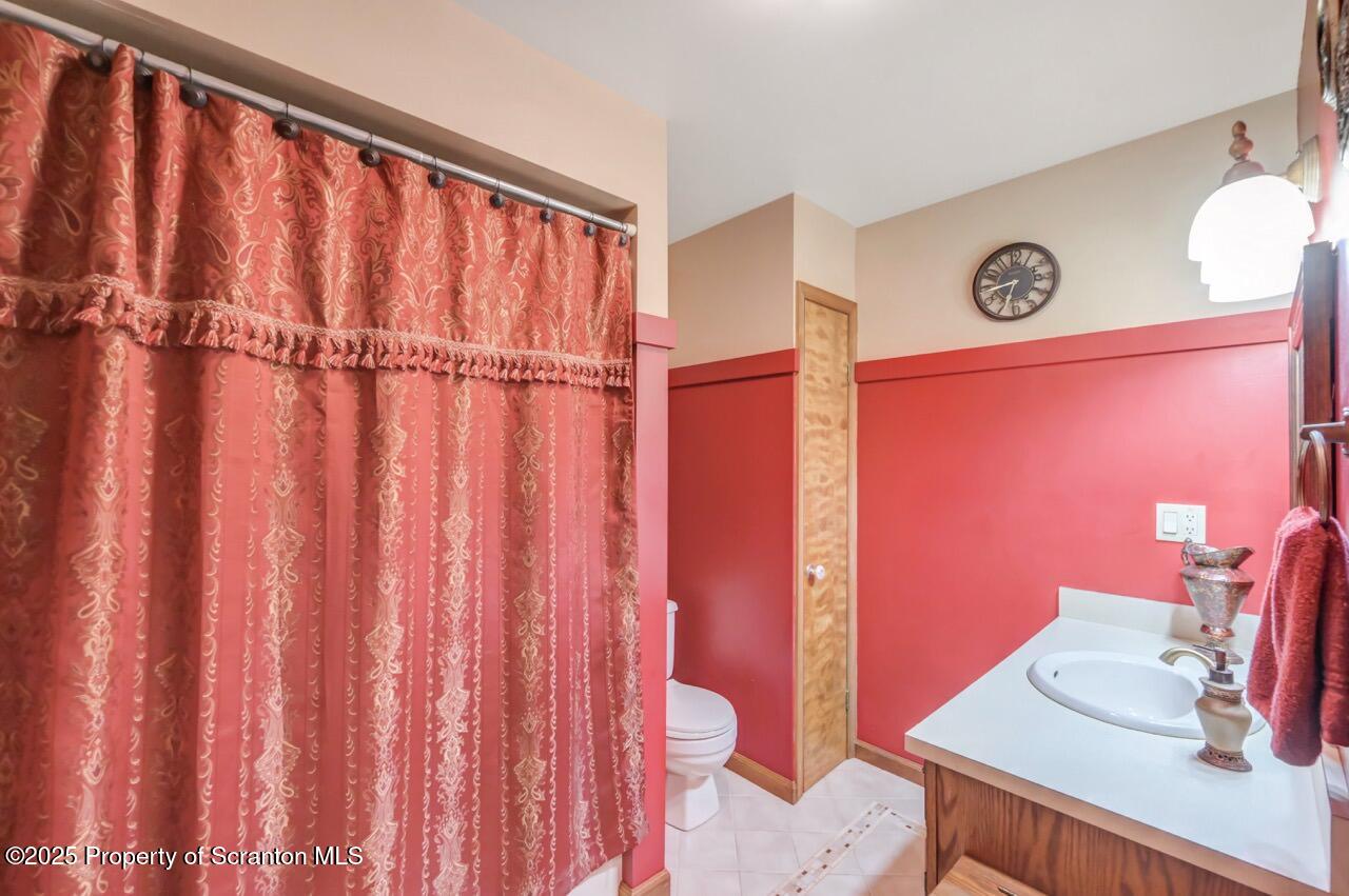 99 Main Street Gouldsboro, PA 18424 - Photo 42 of 79 a bathroom with a sink a mirror and a shower curtain