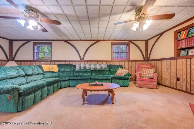 a view of a house with a yard and large trees
