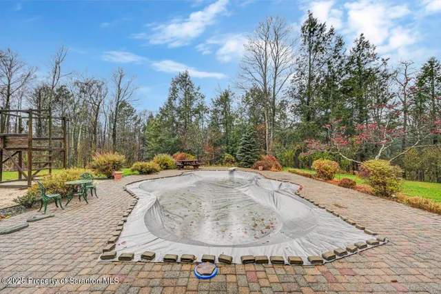 a view of a swimming pool with sitting area