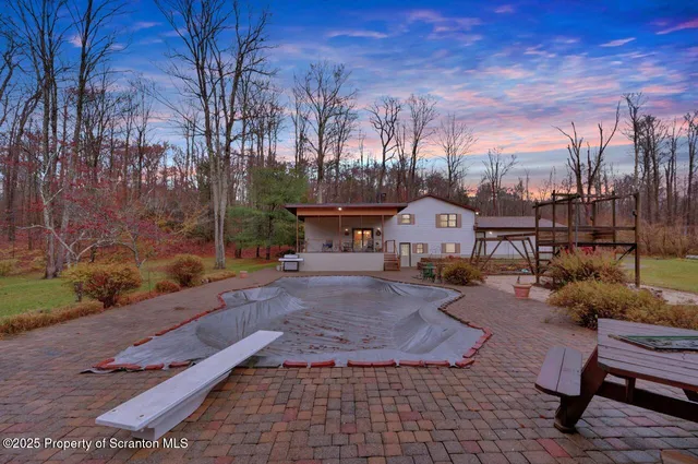 a view of a backyard with sitting area