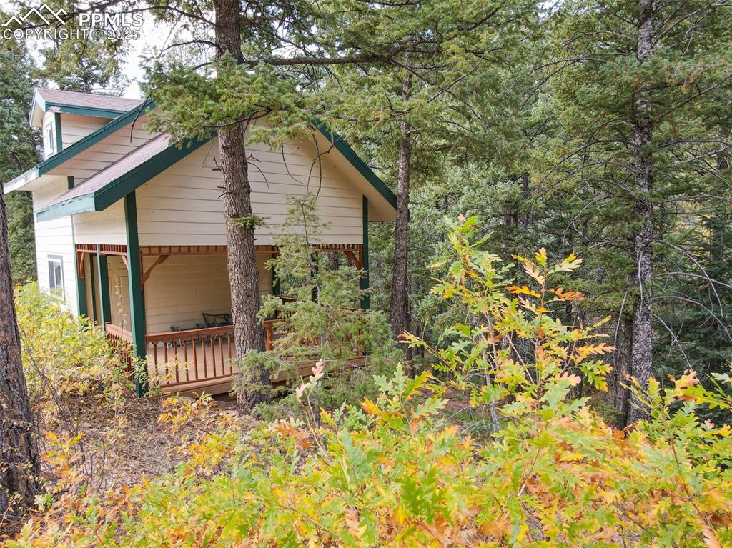 4950 Little Turkey Creek Road Colorado Springs, CO 80926 - Photo 3 of 33 a backyard of a house with plants and wooden fence