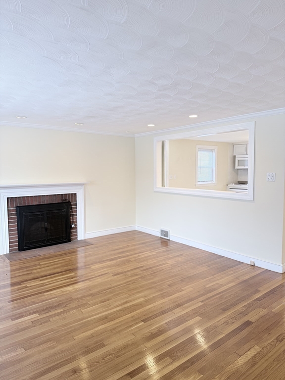 188 Lexington Street Newton, MA 02466 - Photo 4 of 12 a view of an empty room with wooden floor and a window