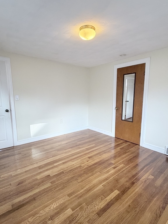 188 Lexington Street Newton, MA 02466 - Photo 5 of 12 a view of empty room with wooden floor and fan