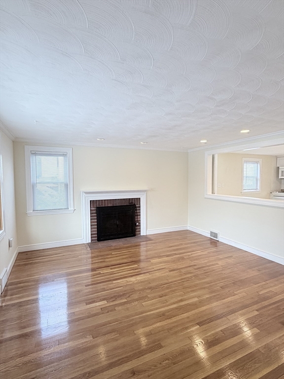 188 Lexington Street Newton, MA 02466 - Photo 7 of 12 a view of an empty room with wooden floor and a window