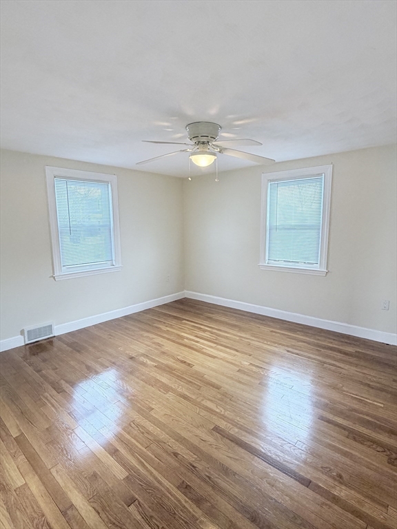 188 Lexington Street Newton, MA 02466 - Photo 9 of 12 a view of an empty room with wooden floor and a window
