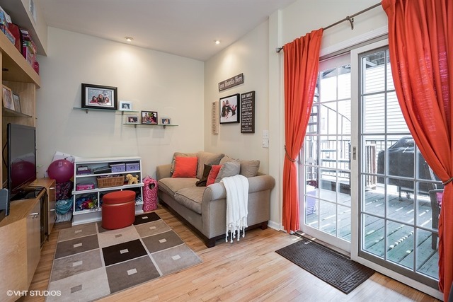 1443 North Mohawk Street, Unit 3 Chicago, IL 60610 - Photo 7 of 16 a living room with furniture a flat screen tv and next to a window
