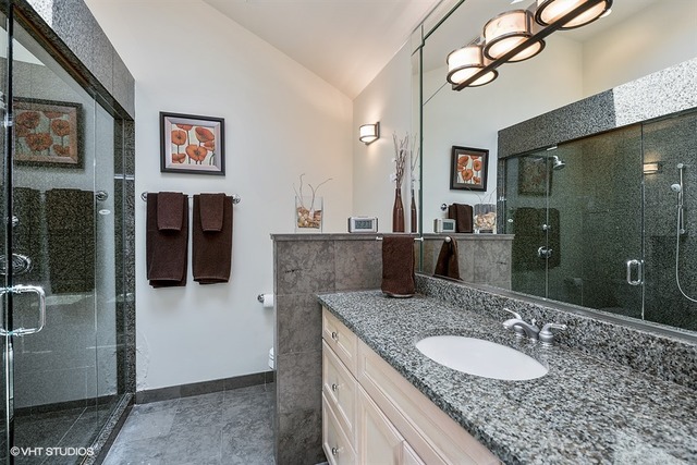 1443 North Mohawk Street, Unit 3 Chicago, IL 60610 - Photo 9 of 16 a bathroom with a granite countertop sink a mirror and shower