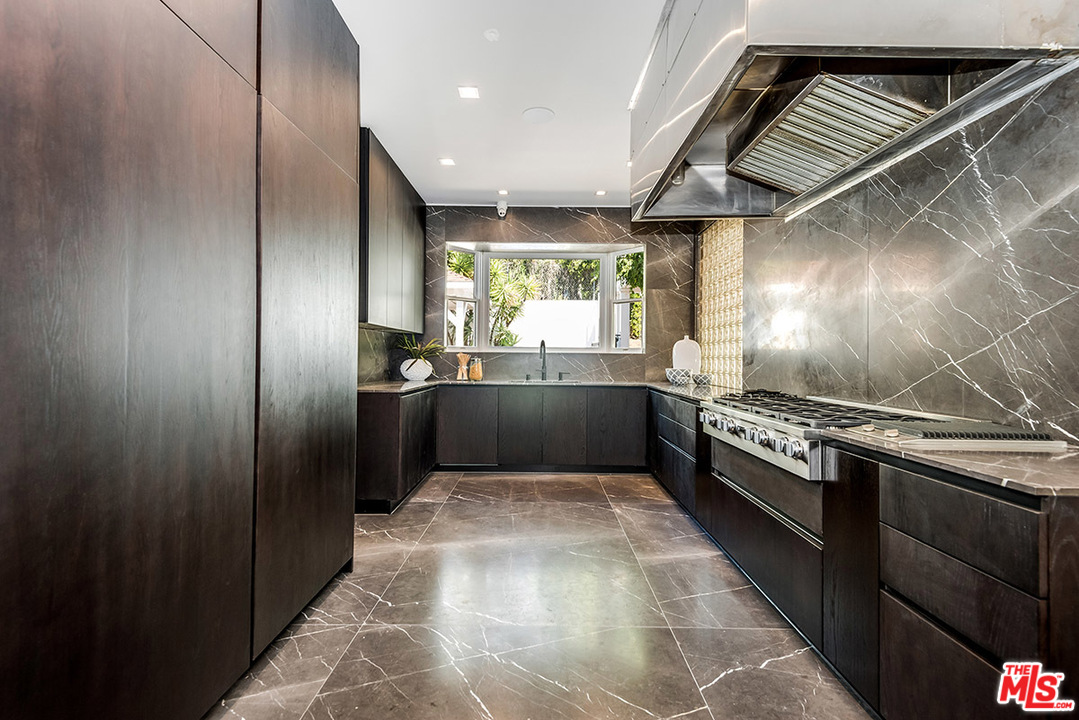 243 Delfern Drive Los Angeles, CA 90077 - Photo 11 of 32 a large kitchen with stainless steel appliances granite countertop a large counter top