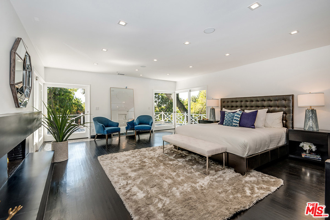 243 Delfern Drive Los Angeles, CA 90077 - Photo 15 of 32 a bed room with furniture and a wooden floor