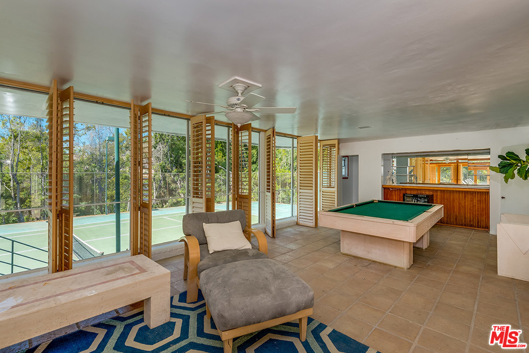 243 Delfern Drive Los Angeles, CA 90077 - Photo 31 of 32 a living room with furniture and a large window