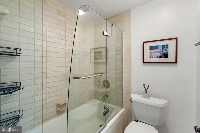 a bathroom with a toilet sink and shower