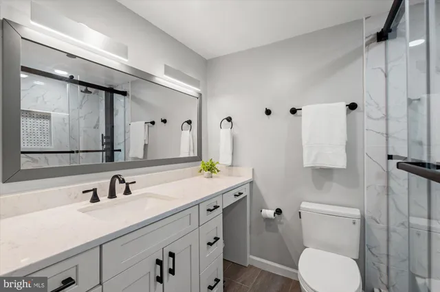 a bathroom with a sink toilet and shower