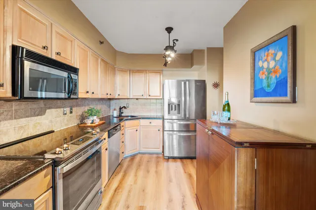 a kitchen with a stove a sink and a microwave