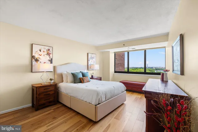 a living room with a bed furniture and a large window