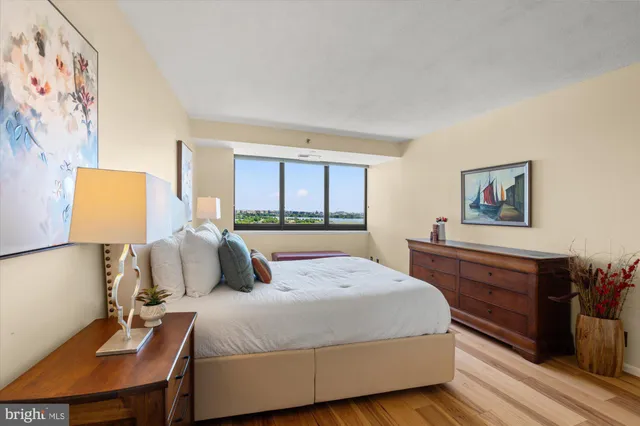 a bedroom with a bed and a dresser with mirror