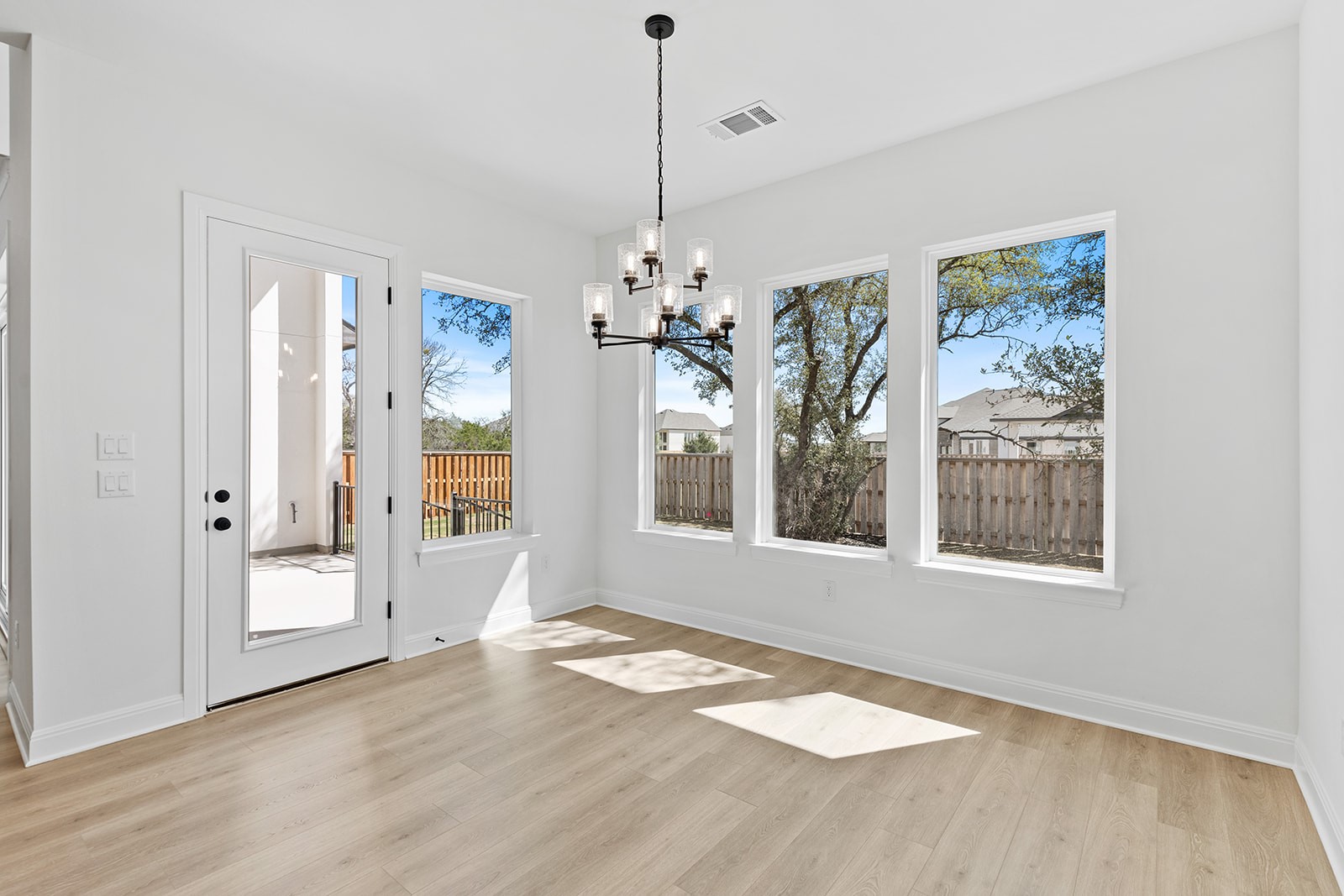 304 Barnstorm Lane Georgetown, TX 78633 - Photo 22 of 40 a view of a room with window wooden floor and chandelier