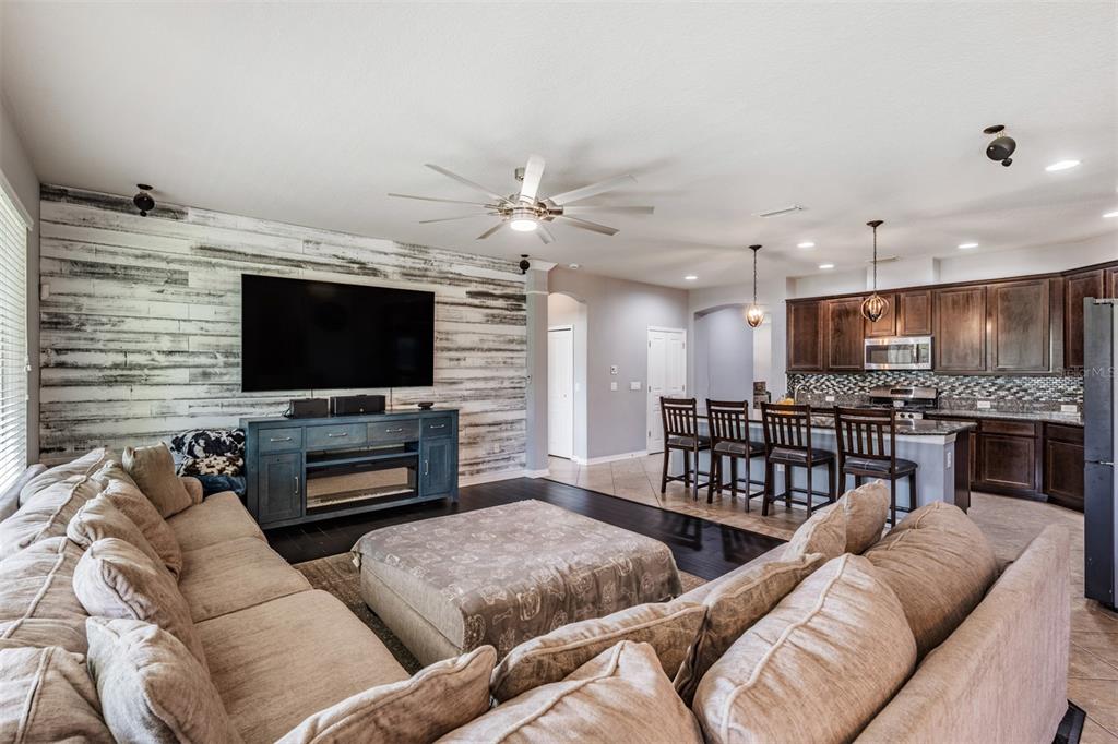 6908 Covington Stone Avenue Apollo Beach, FL 33572 - Photo 17 of 60 a living room with furniture and a flat screen tv