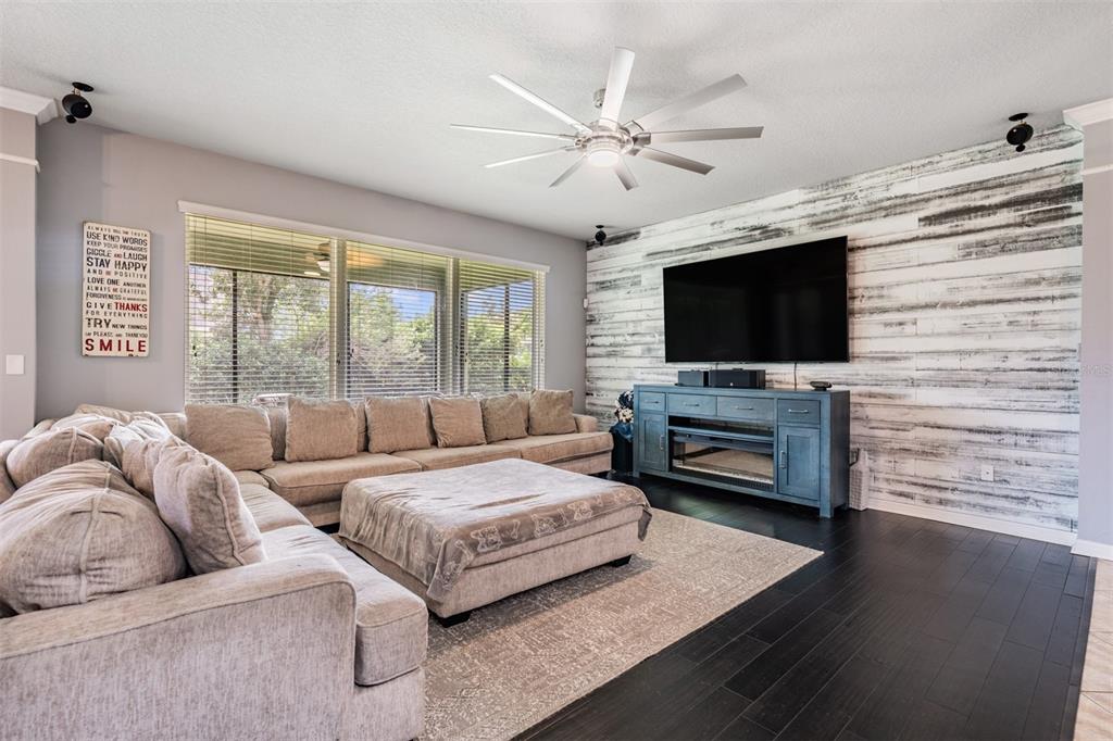 6908 Covington Stone Avenue Apollo Beach, FL 33572 - Photo 18 of 60 a living room with couches and a flat screen tv
