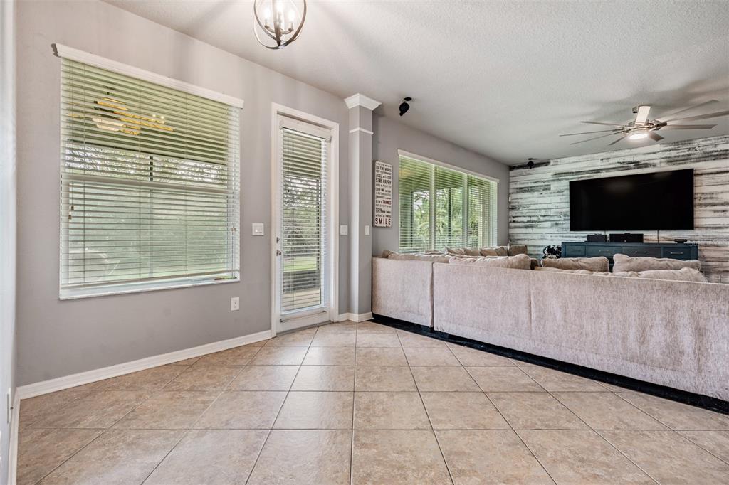 6908 Covington Stone Avenue Apollo Beach, FL 33572 - Photo 19 of 60 a view of livingroom with furniture and flat screen tv