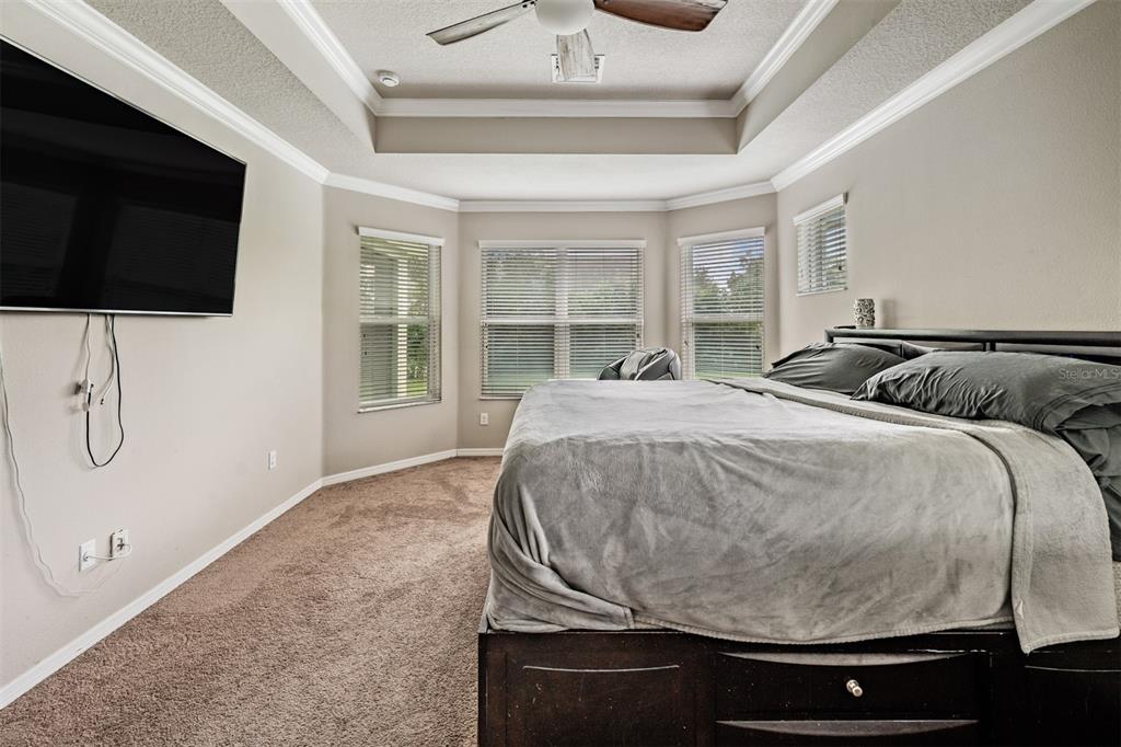 6908 Covington Stone Avenue Apollo Beach, FL 33572 - Photo 22 of 60 a bedroom with a bed and a flat screen tv