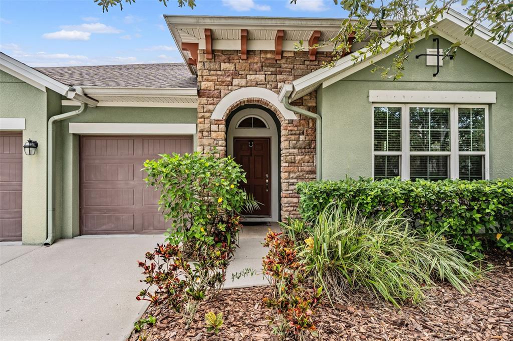 6908 Covington Stone Avenue Apollo Beach, FL 33572 - Photo 5 of 60 a front view of a house with garden