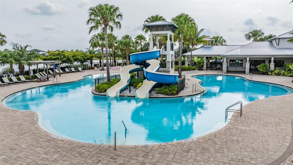 6908 Covington Stone Avenue Apollo Beach, FL 33572 - Photo 52 of 60 a view of a swimming pool with outdoor seating