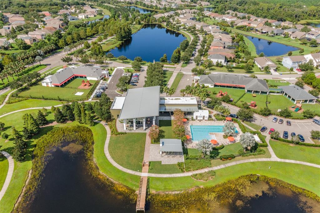 6908 Covington Stone Avenue Apollo Beach, FL 33572 - Photo 57 of 60 an aerial view of a house with a swimming pool yard and lake view
