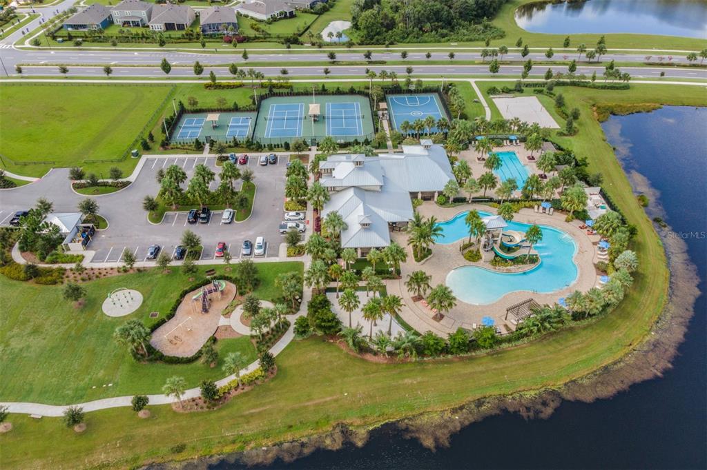 6908 Covington Stone Avenue Apollo Beach, FL 33572 - Photo 60 of 60 an aerial view of a swimming pool with a yard and lake view