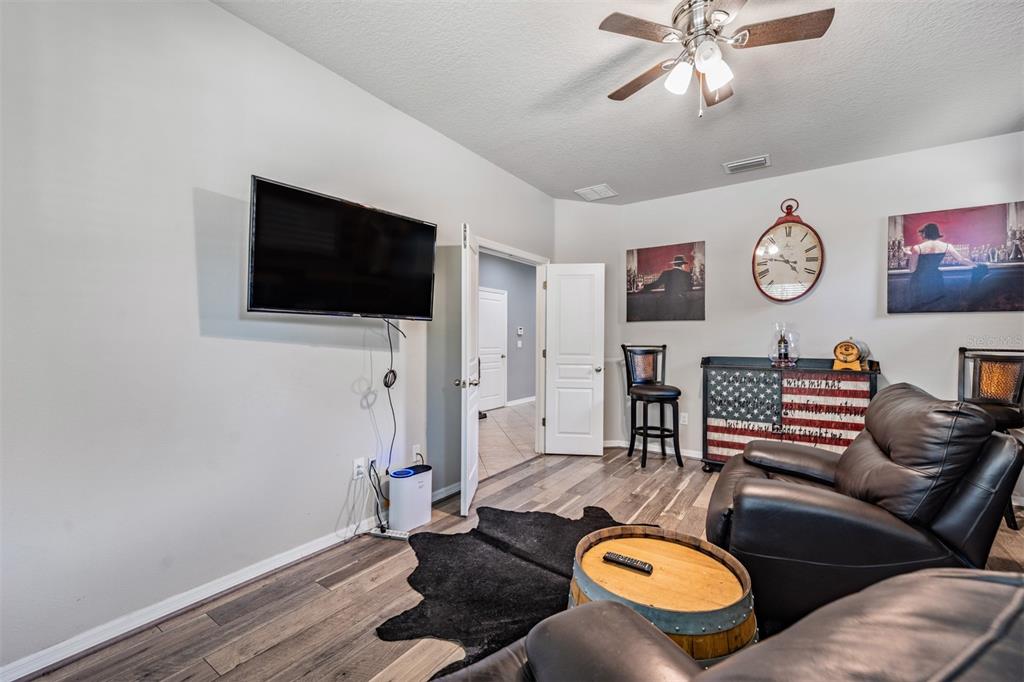 6908 Covington Stone Avenue Apollo Beach, FL 33572 - Photo 8 of 60 a living room with furniture and a flat screen tv