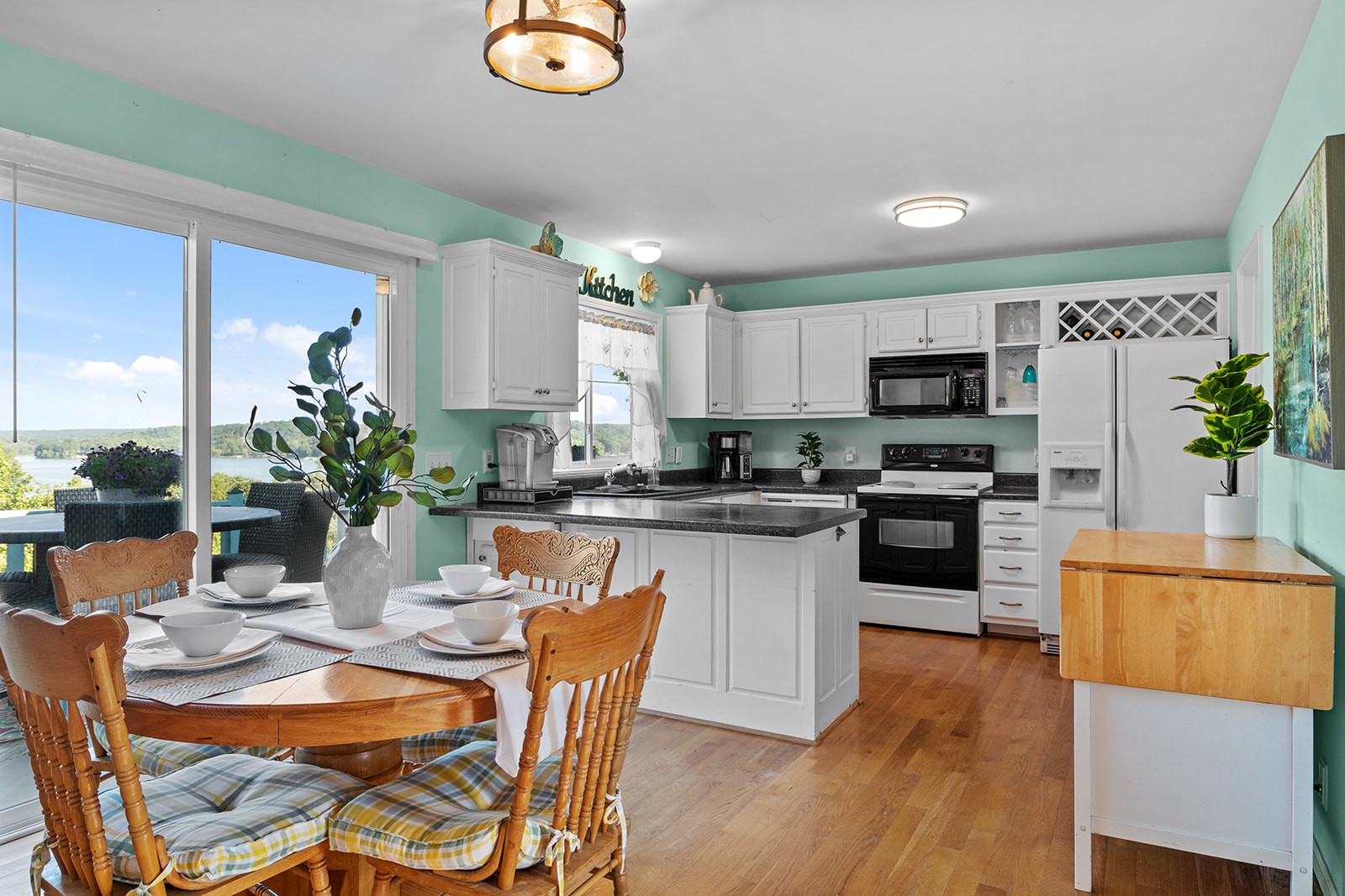 465 Turtle Point Lane Waverly, TN 37185 - Photo 20 of 49 a kitchen with a table chairs microwave and cabinets