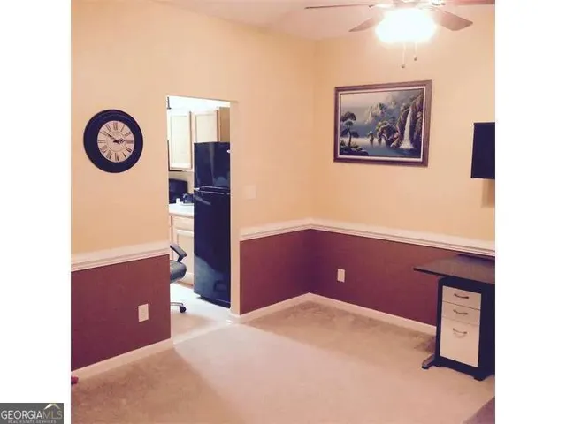 a kitchen with a refrigerator and a stove