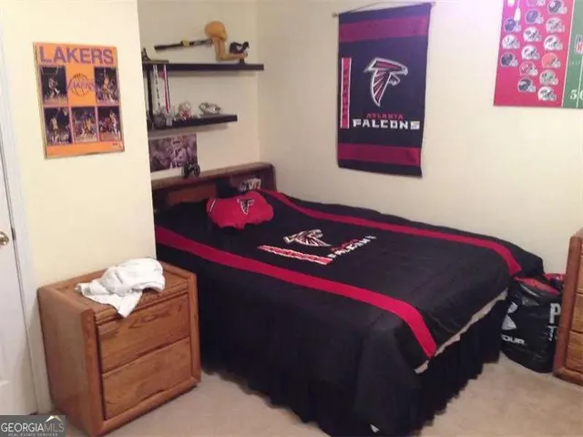 a bedroom with a bed and a desk