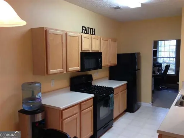 a kitchen with stainless steel appliances a stove microwave and refrigerator