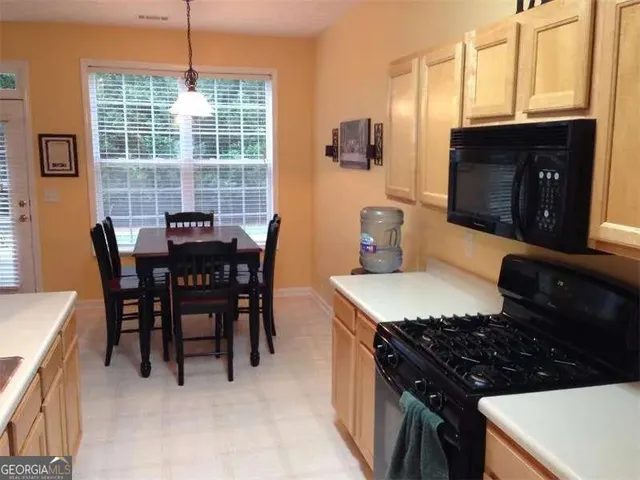 a kitchen with a table chairs and a stove