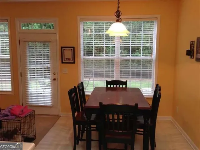 a view of a dining room with furniture and window