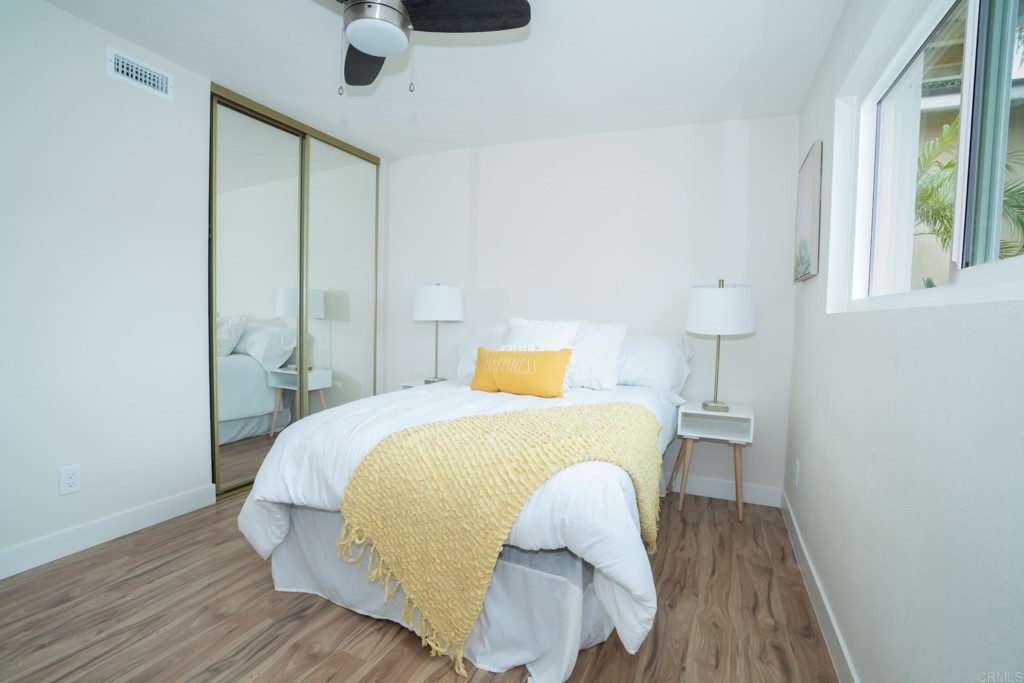 4080 Lake Boulevard Oceanside, CA 92056 - Photo 11 of 28 a bedroom with a bed and wooden floor