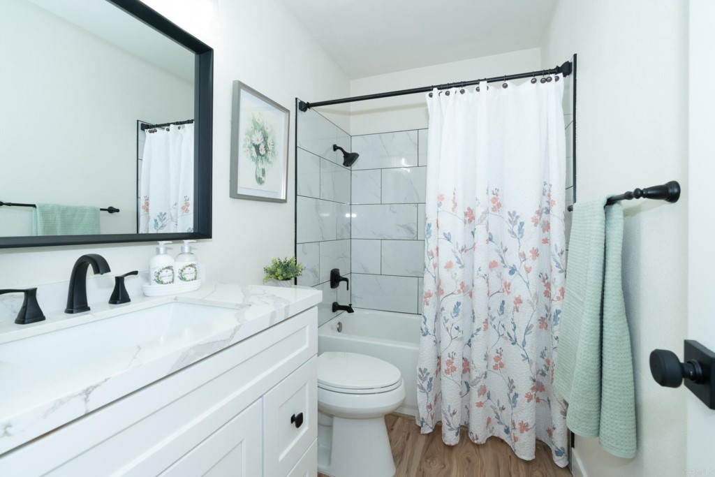 4080 Lake Boulevard Oceanside, CA 92056 - Photo 12 of 28 a bathroom with a sink a toilet and shower curtain