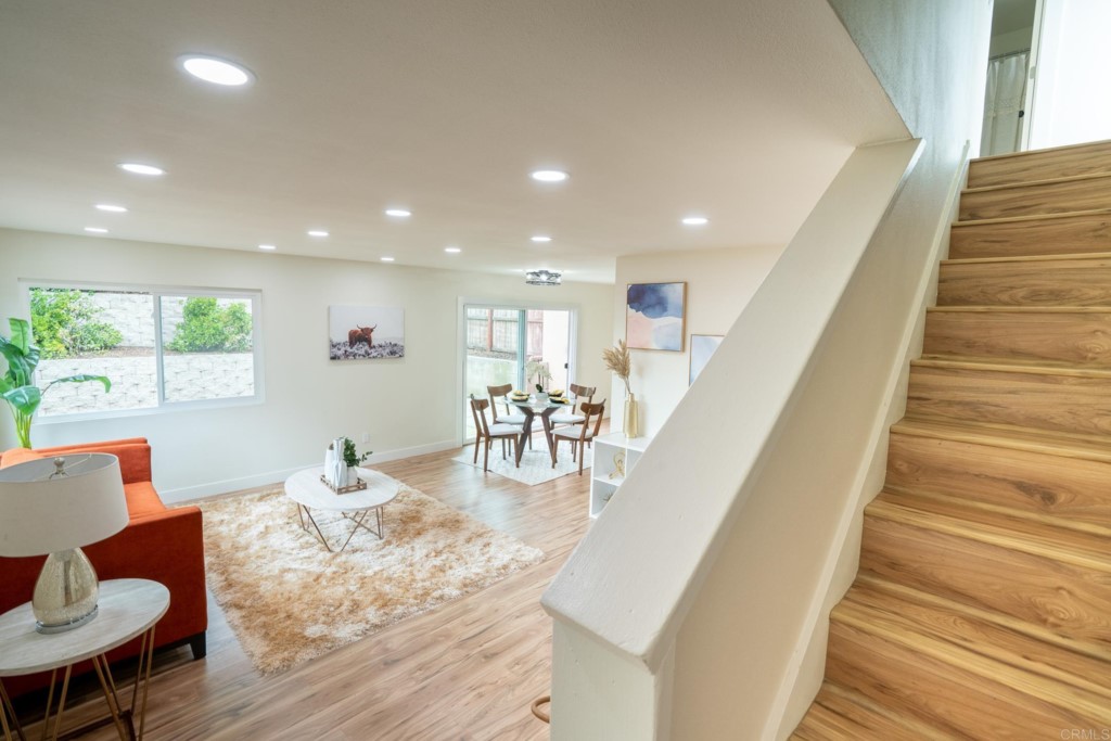 4080 Lake Boulevard Oceanside, CA 92056 - Photo 14 of 28 a living room with furniture and a dining table with wooden floor