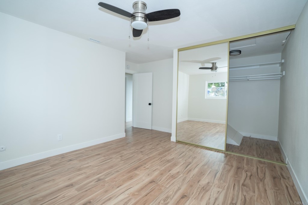 4080 Lake Boulevard Oceanside, CA 92056 - Photo 21 of 28 an empty room with wooden floor and windows