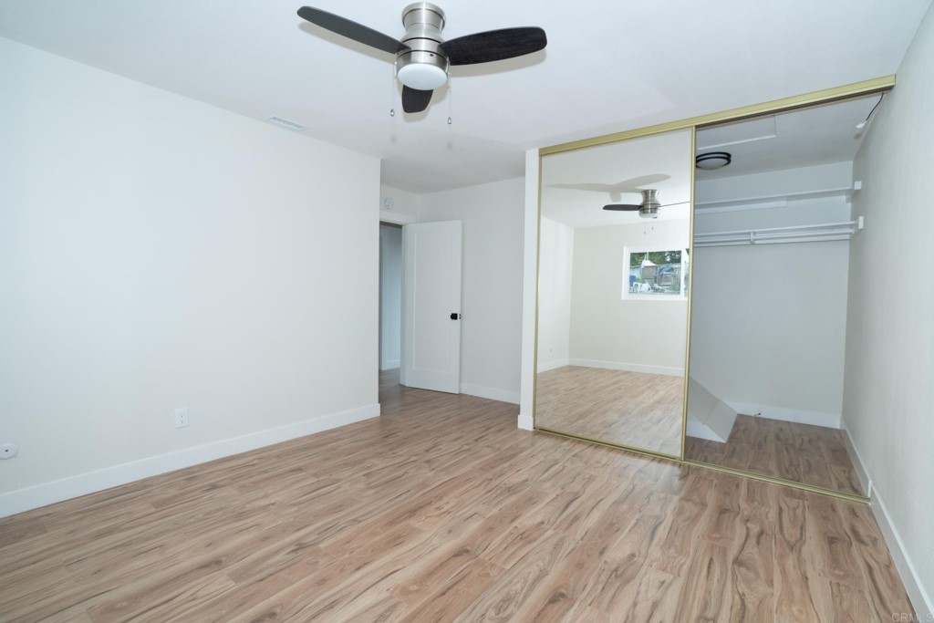 4080 Lake Boulevard Oceanside, CA 92056 - Photo 22 of 28 an empty room with wooden floor and windows